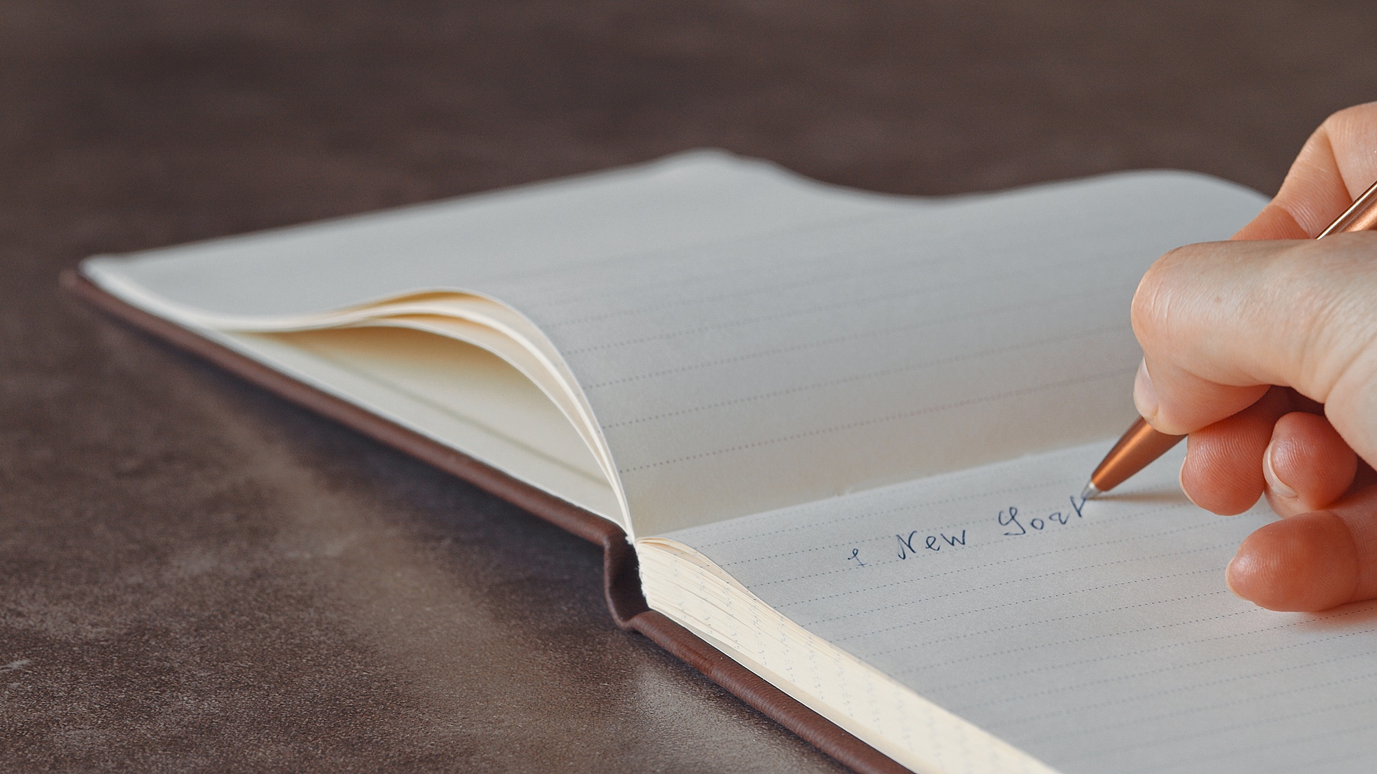 Female hand writing text